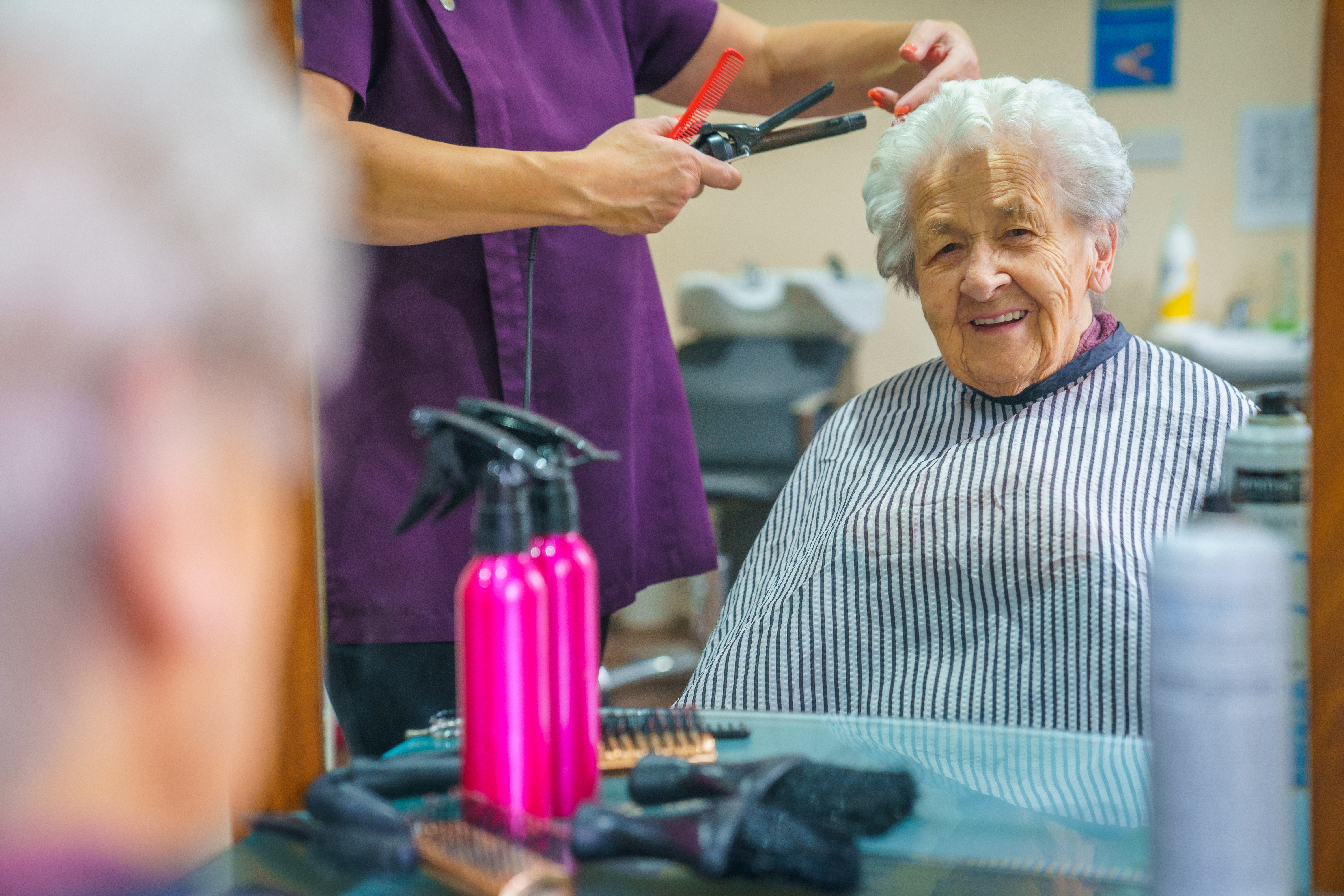 A female resident having their hair done in the salon