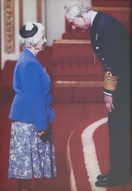 Lorna being awarded an MBE in 2012 by the then Prince Charles. 