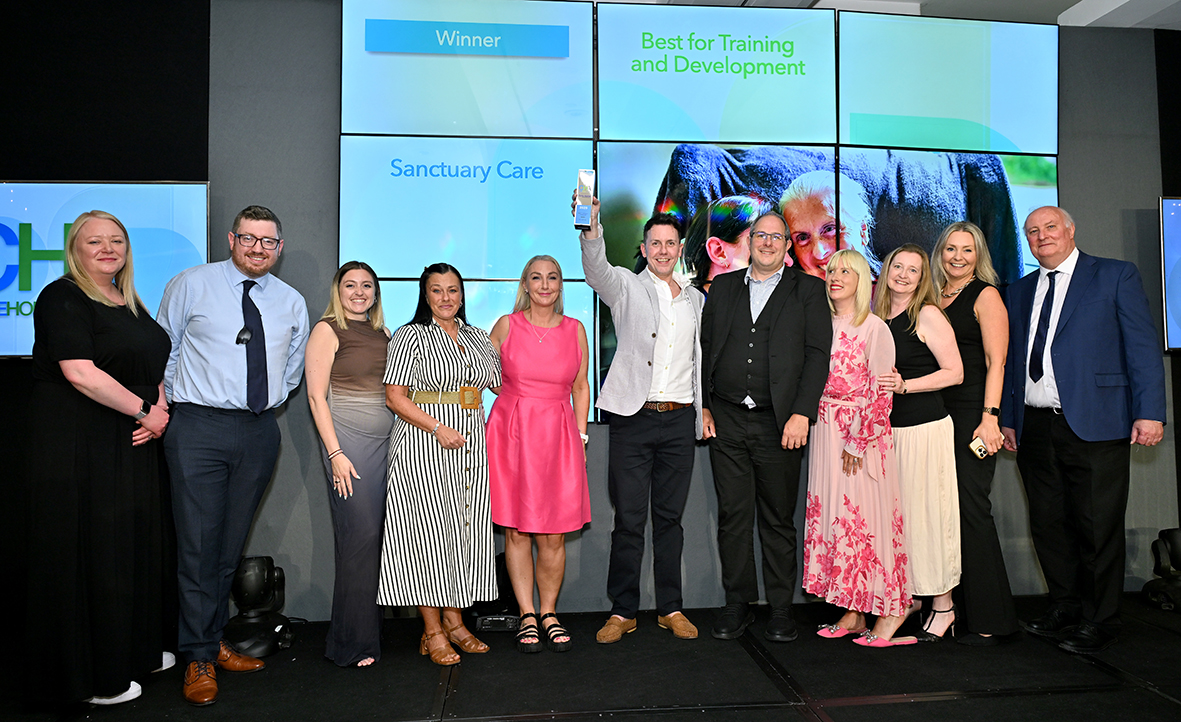 Award Winners For Training and Development Group of professionals holding an award smiling