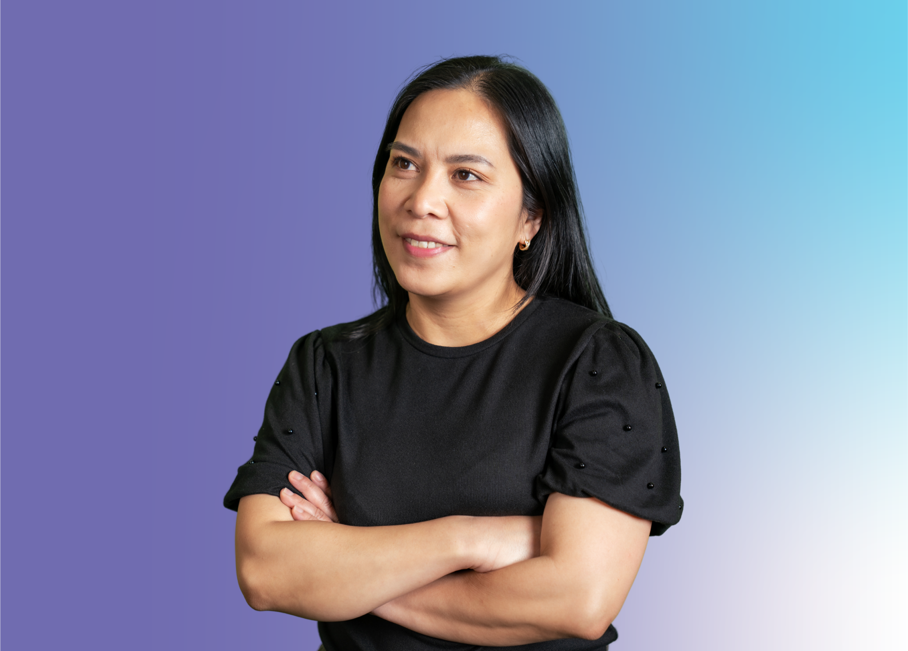 ID07 Jobs home - Make a difference in a place you belong A person standing with folded arms against a blue gradient background.
