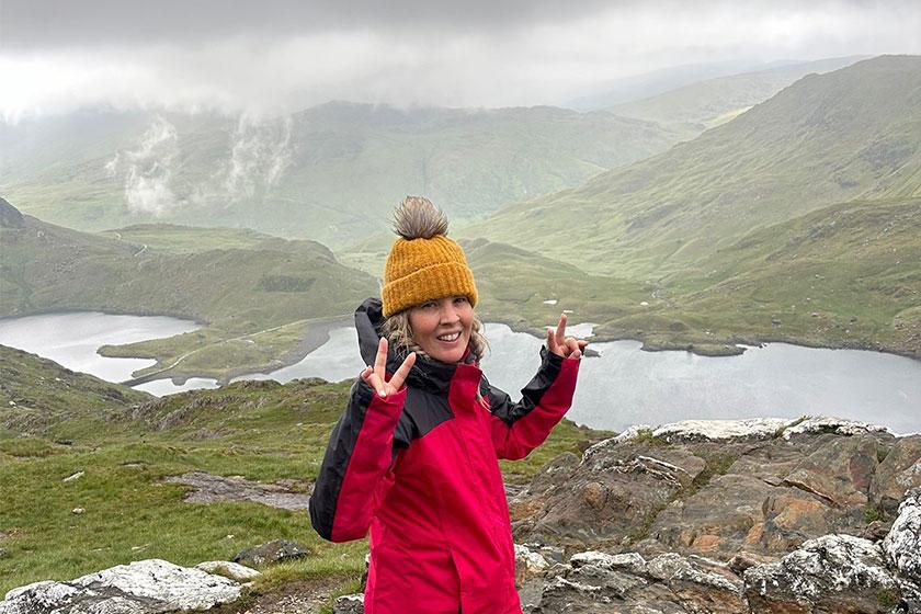 Stacey Meredith, regional manager for Sanctuary Care's homes in Worcestershire, standing at the top of a mountain during her charity three peaks challenge 