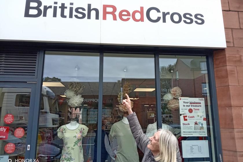 Ann Duffy, a resident at Queens Care Home in Prestwick, outside the charity shop she is volunteering at 