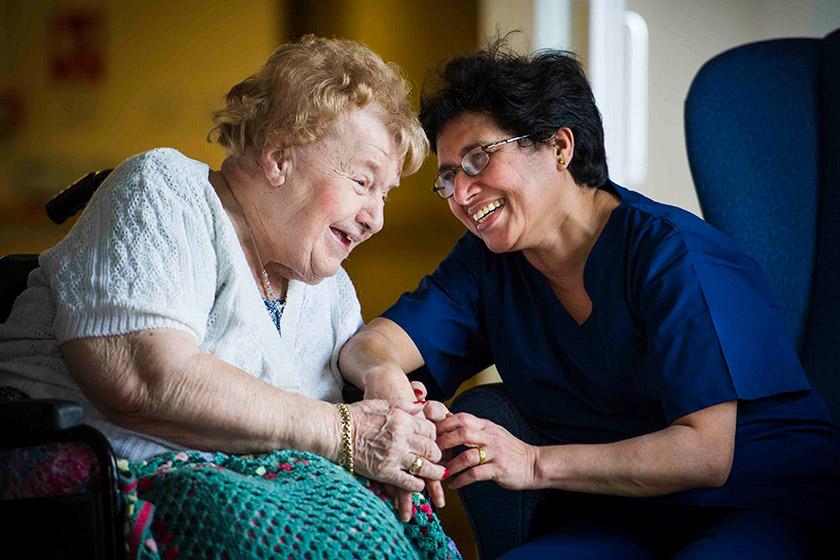 Tila Pokhrel and resident Doreen Foster smiling together