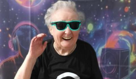 Resident smiling and dancing wearing sunglasses