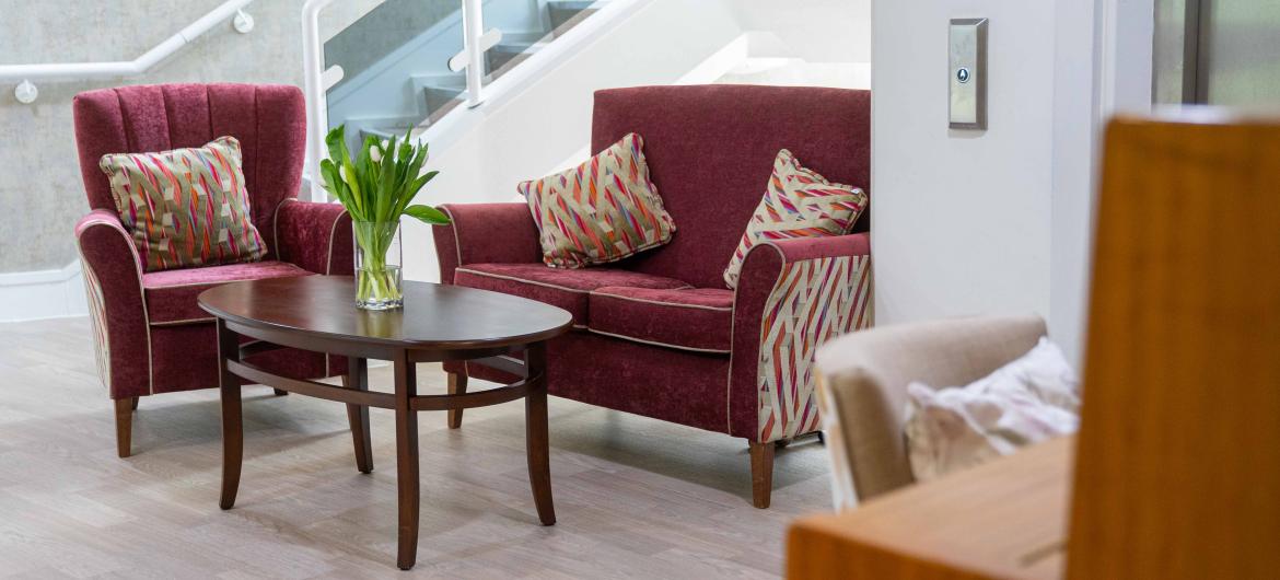 Two chairs around a coffee table in a clean modern reception area