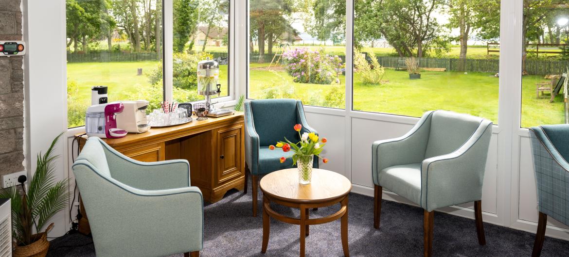 Seating area in the conservatory at Mull Hall Care Home in Invergordon. 