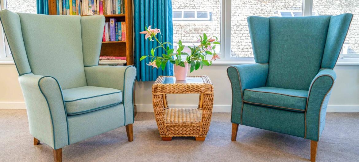 The Green seating area Two oversized arm chairs located next to a large window.