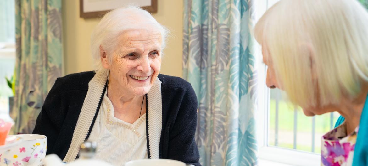 Staff and resident smiling