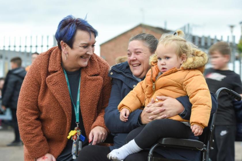A Sanctuary employee chatting and smiling with residents