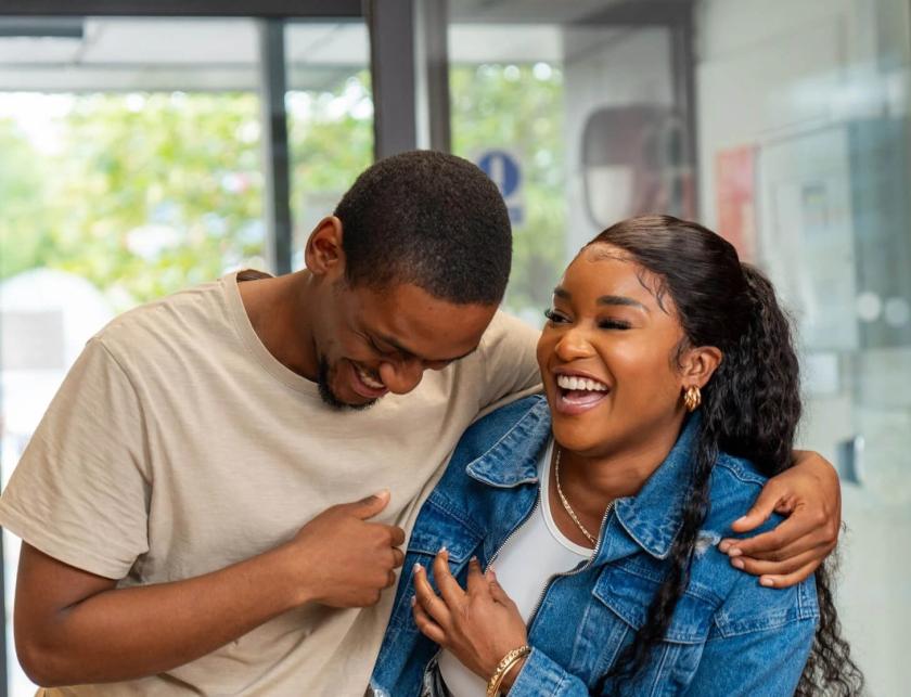 Two students laughing together