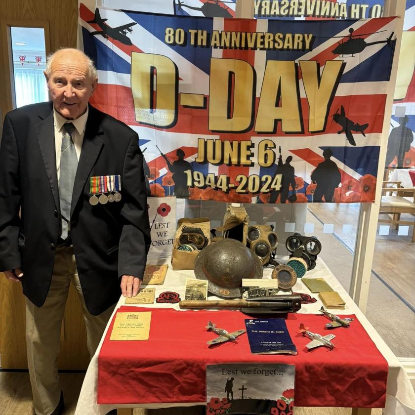 Resident David stood next to a table of war memorabilia during the 80th anniversary of d-day