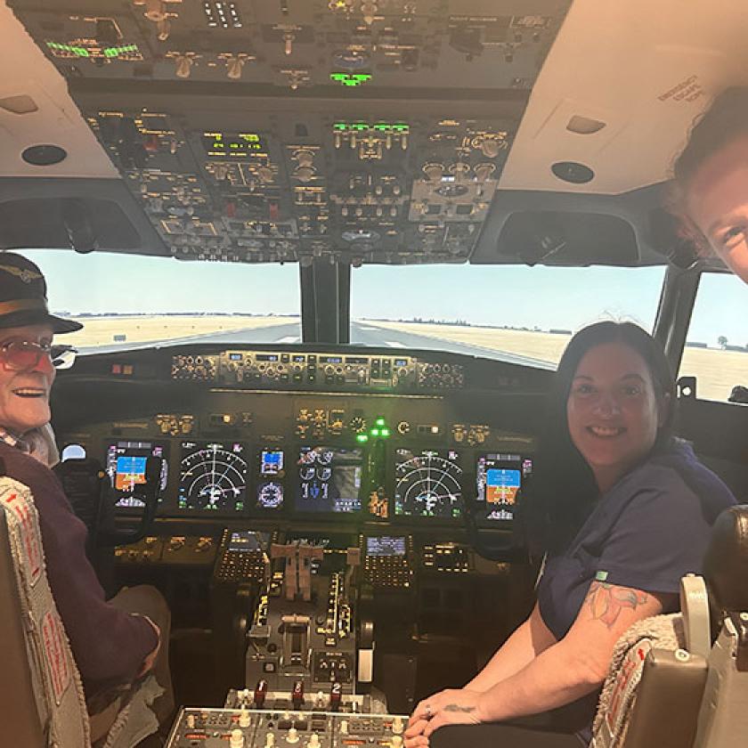 David Auld beams with joy as he enjoys a flight simulator experience with wife Jean and two staff from Queens Care Home in South Ayrshire 