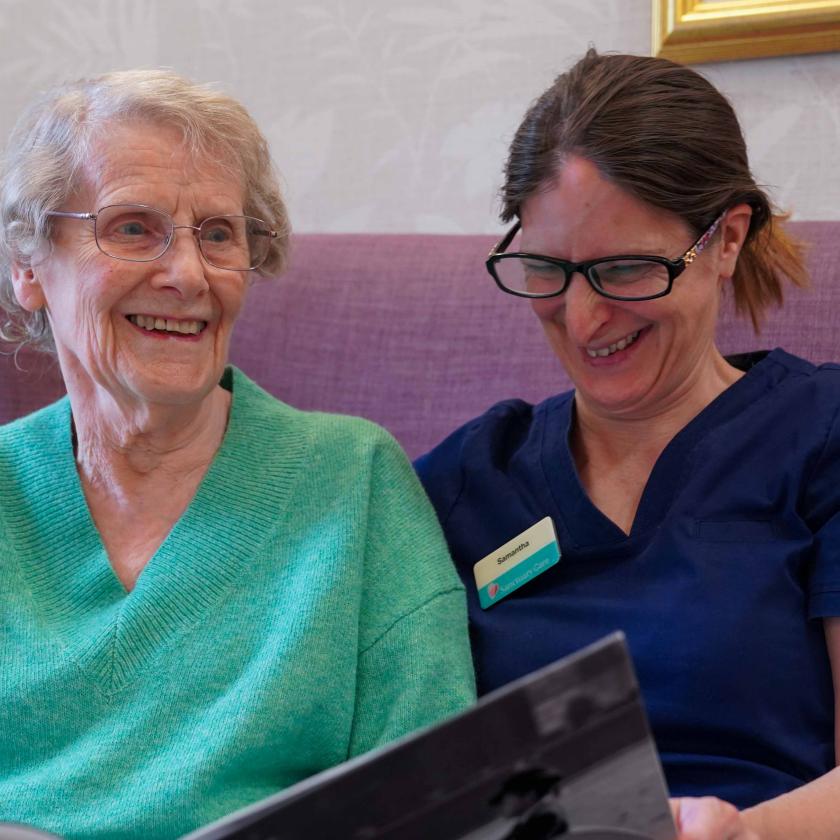 Photo of elderly lady with carer smiling 