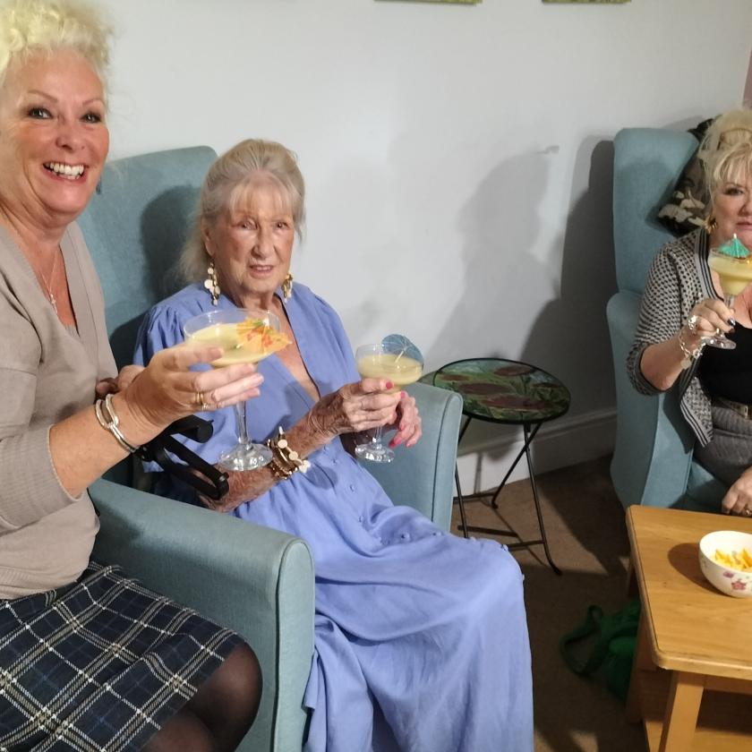 Residents and their loved ones enjoying a cocktail and snacks