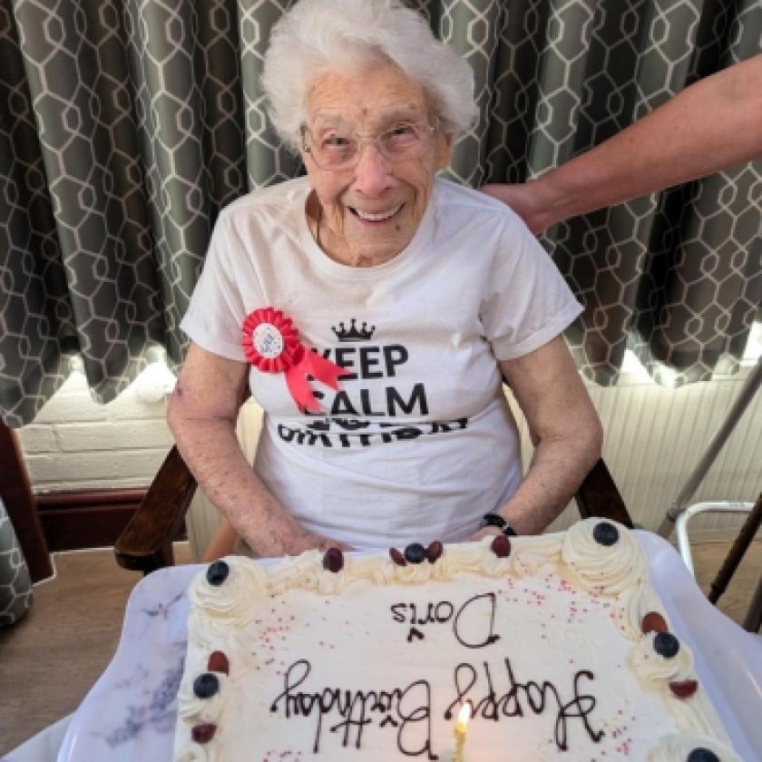 Resident, Doris smiling with her birthday cake