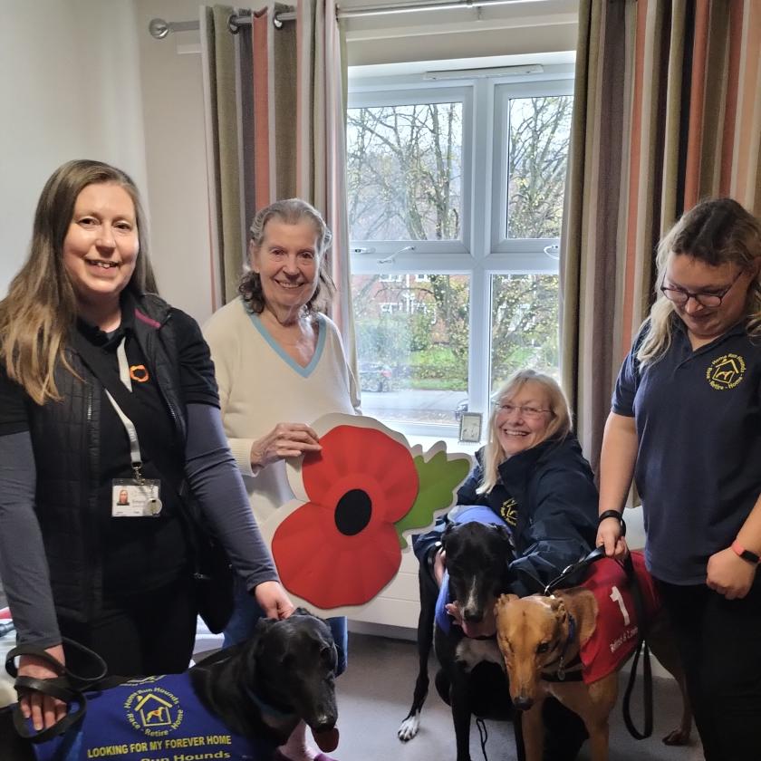 A resident and three women from Home Run Hounds who look after retired greyhounds 