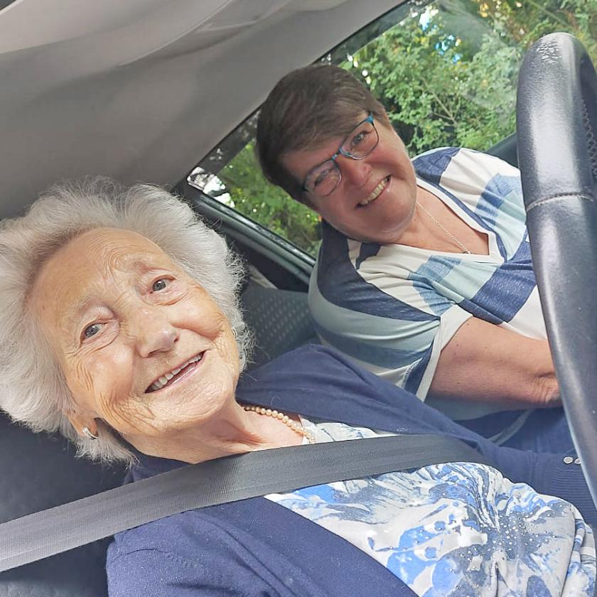 Cicely beams behind the wheel of the car with Karen, a driving instructor