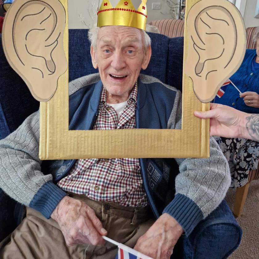 Resident Ken Brearly, wearing a crown to celebrate the King's Coronation