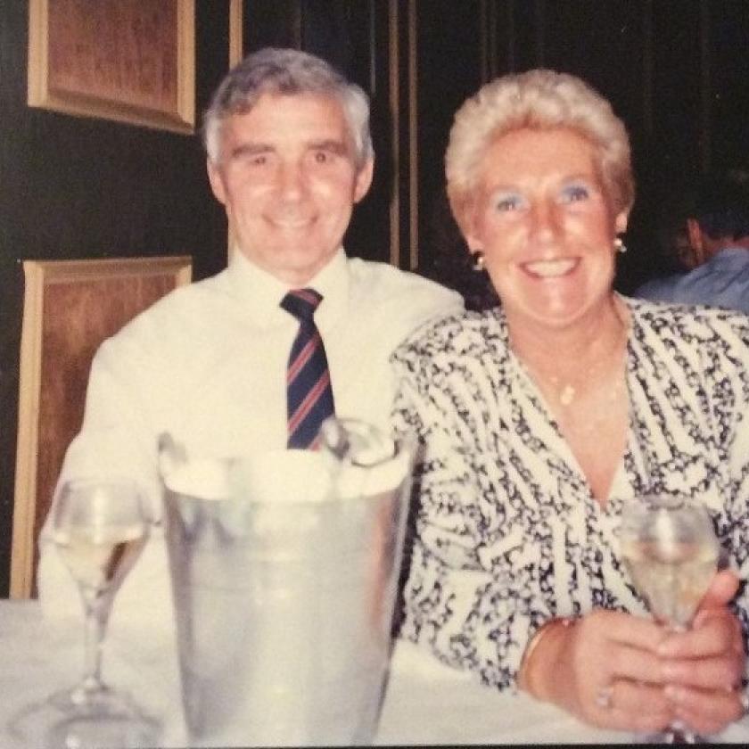 A photograph of a happy couple enjoying a glass of wine with each other