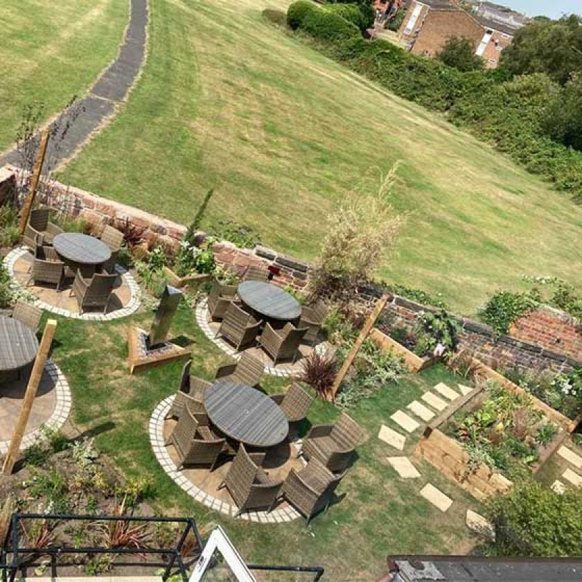 An aerial view of the garden space with patio furniture